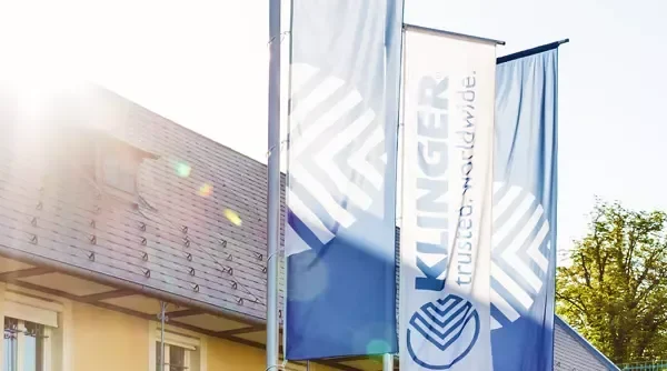 klinger holding building with flags displayed in front