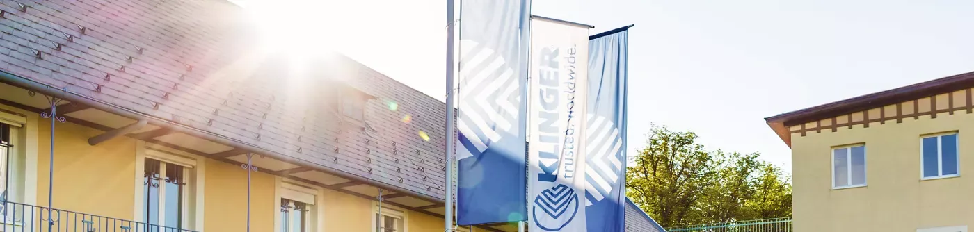 klinger holding building with flags displayed in front