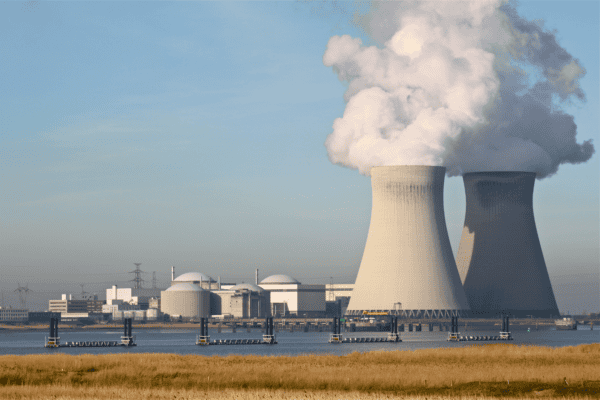 nuclear plant showing active smoke bellowing from reactors