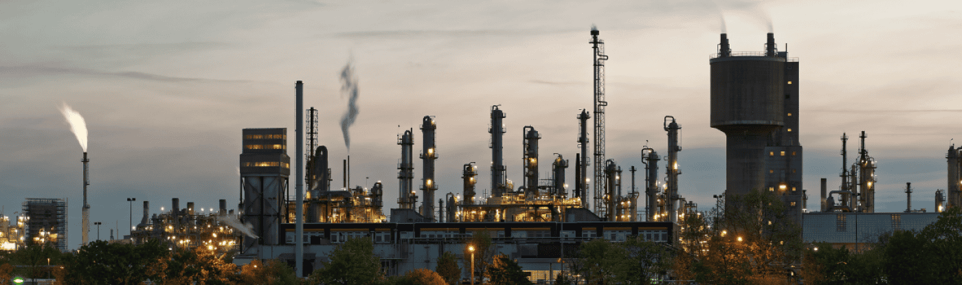 industrial plant lit up at dusk
