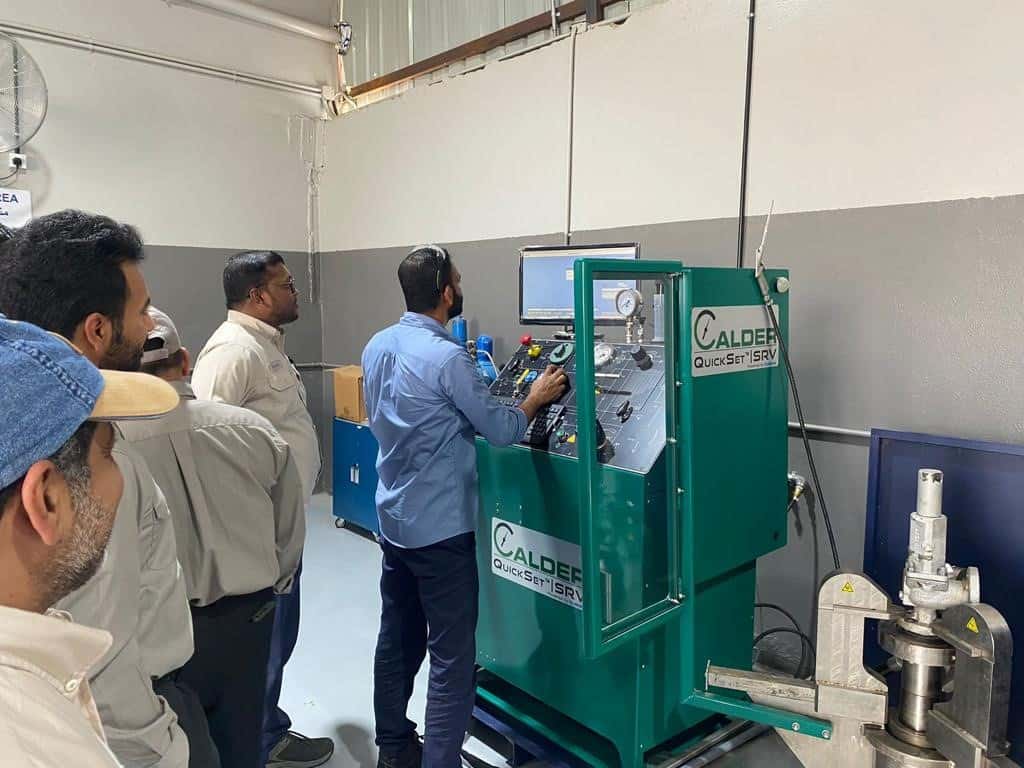 klinger uk saudi arabia workshop with employee demonstrating computers to people
