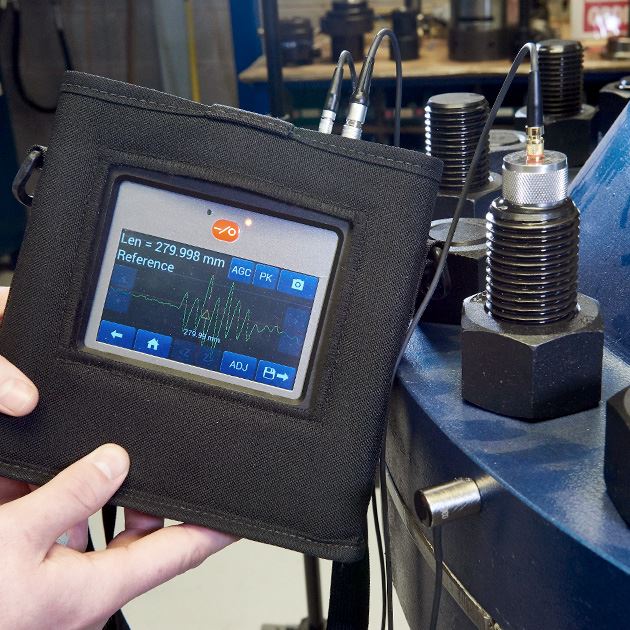 klinger uk employee showcasing apparatus for ultrasonic monitoring