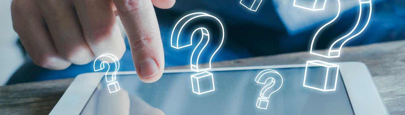 Finger touching a mobile device with question marks surrounding it