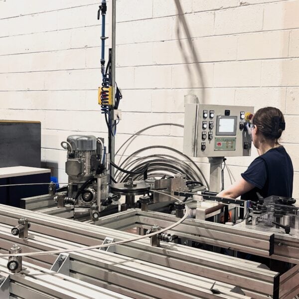 Female KLINGER UK employee using computer system to manufacture metallic gasket